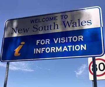 Sign_at_NSW_and_QLD_border_crossing_Numinbah_Road_Numinbah_New_South_Wales